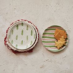 two plates with cookies on them sitting next to each other in front of a wall