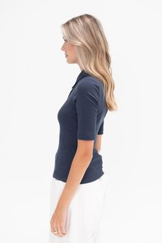 polo collar elbow-length sleeves front button placket fitted silhouette 100% gots cotton made in usa model is wearing smodel is 5’11", a us 4 and s in tops