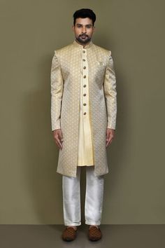 Gold and yellow full sleeves layered sherwani crafted in jacquard silk with prism helix pattern detailing on the outer layer and plain front button detail inner layer. Paired with a cream Aligadhi pant. - Aza Fashions Yellow Kurta With Naqshi For Wedding, Yellow Naqshi Kurta For Wedding, Yellow Bandhgala For Wedding, Yellow Bandhgala For Wedding And Transitional Season, Yellow Fitted Bandhgala For Wedding, Yellow Sherwani With Dabka Traditional Drape, Ceremonial Yellow Sherwani With Pallu, Traditional Drape Yellow Sherwani With Dabka, Gold Brocade Sherwani With Cutdana