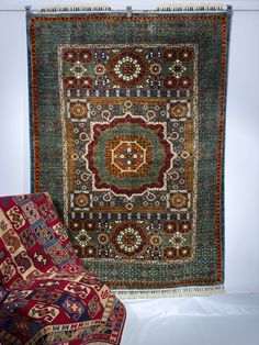 two rugs are sitting next to each other on the floor in front of a white wall