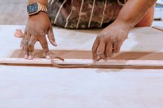 a person with their hands on a ruler