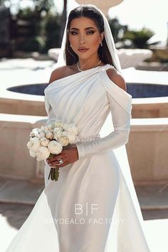 a woman in a wedding dress holding a bouquet