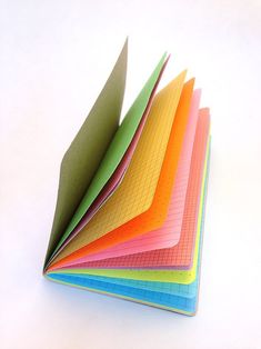 a stack of colored papers sitting on top of each other