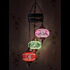 three colorful lights hanging from a ceiling