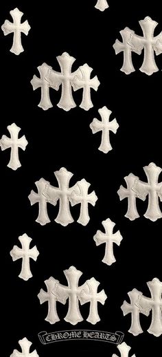 several white crosses are arranged on a black background