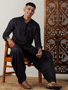 Vastramay Men's Black Mirror Georgette Kurta With Patiala Set Make a statement in this elegant black kurta with a stylish mirror work design. The georgette fabric adds a touch of luxury, perfect for festive occasions or special events. Features: Black georgette kurta with mirror work Patiala set for a complete traditional look Comfortable and stylish Specifications: Brand: VASTRAMAY Color: Black Fabric: Georgette Neck: Mandarin Collar Sleeve Length: Full Sleeves Material & Care: Georgette, Dry-c Black Straight Kurta For Party, Black Semi-formal Kurta For Festive Occasions, Elegant Black Sequined Kurta, Black Kurta For Party, Black Sherwani With Mirror Work For Party, Black Traditional Wear For Festive Semi-formal Occasions, Black Semi-stitched Bandhgala For Festive Occasions, Festive Semi-stitched Black Bandhgala, Black Semi-formal Traditional Wear For Festive Occasions