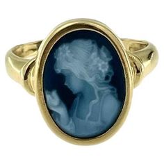 The Retro French Yellow Gold Ring with Agate Cameo is a striking piece that captures the elegance and refinement of vintage jewelry. Crafted from luxurious 18kt yellow gold, this ring features a beautifully detailed agate cameo, meticulously carved to depict the portrait of a girl. In the Middle Ages, wearing agate was thought to cure insomnia and ensure sweet dreams. A variety of quartz, agate is a common, semiprecious chalcedony. The agate cameo is bezel set, ensuring it is securely held while Cameo Rings, French Yellow, French Jewelry, Cameo Ring, The Middle Ages, Victorian Rings, Yellow Gold Setting, Agate Ring, Gold Hands