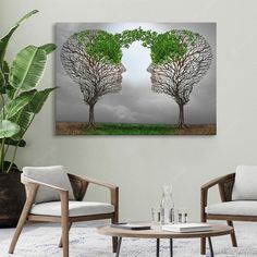 two trees are facing each other in the middle of a room with chairs and a coffee table