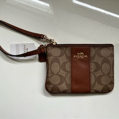 Brown/Tan Coach Wristlet, Style F52850. Brand New, Never Used, With Tags. Care Instructions Included. About 6 Inches Wide And 4 Inches Tall (See Pics). Does Not Include Official Coach Box. Zip Top, 2 Credit Card Slots Interior. Let Me Know If You Have Any Questions! Brown Wristlet For Everyday Use, Brown Wristlet With Zipper Pouch For Daily Use, Brown Coach Bag With Wrist Strap, Brown Handheld Wristlet With Zipper Pouch, Coach Brown Coin Purse For Travel, Brown Wristlet With Wrist Strap, Brown Handheld Wristlet With Wrist Strap, Coach Brown Wristlet With Zipper Closure, Brown Coach Wristlet Pouch