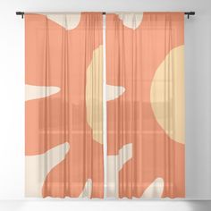 an orange and white abstract design sheer curtain with the sun in the distance behind it