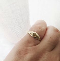 Elegant and unique 14k gold Daffodil signet ring, Vintage style floral wedding band, unique gold wedding ring for the stylish bride to be set with a tiny diamond. * Band width: 1.5 mm, wide part width: 5.5 mm* Thickness: 1.5 mm* Embedded with a one round 1 mm diamond, VS1 F. * Available in 14K or 18K YELLOW, WHITE and ROSE gold.   The price listed is for 14K please contact me for 18K pricing.* available with darkend flower ( please mention in note to seller) * Sizes vary from 5 US to 9 US, inclu Heirloom 14k Gold Engraved Flower Ring, Heirloom Engraved 14k Gold Flower Ring, Delicate 14k Gold Birth Flower Rings, Gold Signet Ring With Birth Flower For Wedding, Elegant Gold Signet Ring With Birth Flower, Gold Wedding Signet Ring With Birth Flower, Elegant Signet Ring With Birth Flower For Anniversary, 14k Gold Flower Promise Ring, 14k Yellow Gold Rings With Birth Flower Detail