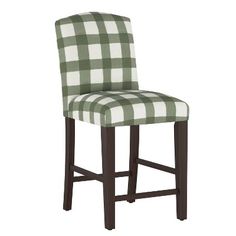 a green and white checkered bar stool with dark wood legs on an isolated white background