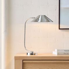 a lamp on top of a wooden dresser