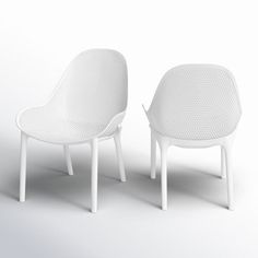 two white chairs sitting next to each other