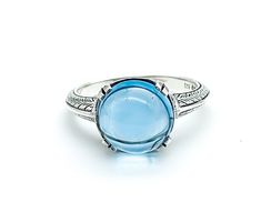 "Art Deco Sterling Silver Pools Of Light Blue Topaz Ring Up for offer is a stunning art deco revival solid sterling silver genuine blue topaz pools of light cabochon ring. Rings are marked \"925\". Measurements Blue Topaz: 10mm x 10mm x 5.5mm/ 5.27cttw Bad Width: 2mm Weight: 3.3 g Materials -Sterling Silver -Blue Topaz Condition: New; Please look closely at the pictures provided as they are an extension of the written description. This item comes from a clean, smoke free household. Item will shi Blue Cabochon Fine Jewelry Ring, Blue Cabochon Dome Ring, Blue Cabochon Ring In Fine Jewelry Style, Fine Jewelry Blue Cabochon Ring, Blue Domed Jewelry With Polished Finish, Blue Domed Cabochon Jewelry, Blue Domed Gemstone Ring, Blue Cabochon Topaz Ring Gift, Formal Cabochon Blue Topaz Jewelry