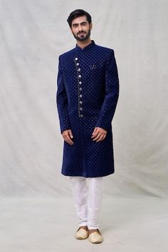 Midnight blue full sleeves layered sherwani crafted in velvet silk with Wildbloom motif thread embroidery using sequin highlights. Paired with an off white Aligadhi pant. - Aza Fashions Traditional Velvet Bandhgala For Wedding, Velvet Bandhgala For Eid Festivities, Festive Velvet Long Sleeve Sherwani, Eid Velvet Fitted Bandhgala, Traditional Velvet Bandhgala For Festive Occasions, Festive Velvet Bandhgala With Long Sleeves, Fitted Velvet Bandhgala For Eid, Festive Long Sleeve Velvet Bandhgala, Blue Sherwani With Zari Work For Winter