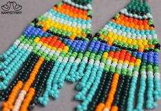 These colorful beadwork earrings are made of high-quality Czech beads and strong synthetic thread. They are elegant, fashionable, and highly versatile, suitable for everyday wear. Features: Sterling silver components Color: Gray, black, yellow, turquoise, blue, green, orange, red. This item is currently in stock. You must be completely satisfied. If you find merchandise unsatisfactory for any reason, return it within 10 days and your money will be refunded without questions. More beaded earrings Beadwork Earrings, Native American Earrings, Long Gold Earrings, Yellow Turquoise, Earrings Geometric, Stylish Earring, Earrings Long, Earrings Blue, Seed Bead Earrings