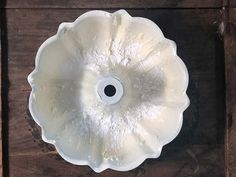 a white bowl sitting on top of a wooden table