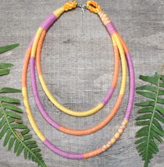 One of a kind piece of colorful african style necklace - completely hand woven with organic cotton threads. Perfect soft statement necklace in optimistic colors  to add joy to your everyday styling. The colors are carefully selected to create a chunky rope necklace that will make you stand out from the crowd. You can be sure of uniqueness. My designs are rare in one or few copies and created with care for the natural environment.  DETAILS: - Colors - multicolor - lightweigh, soft and adjustable - 100% eco friendly, zero waste and slow  - travels in eco packaging ready for a gift  SIZE: Circuit - approx.  -  the shortest and longest string along with the clasp are measured. -18 - 22 inches + 2,5" adjustable chain  -46 - 56 cm + 7 cm adjustable chain Production method: Made by my hand of 100 African Style Necklace, Pink Statement Necklace, Yellow Orange Pink, Style Africain, Jaune Orange, Fabric Necklace, Bib Necklaces, African Style, Rope Necklace