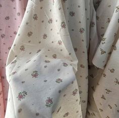 the fabric is white with pink flowers on it