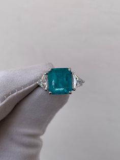 Paraiba Tourmaline Ring, Paraiba Engagement Ring, 925 Sterling Silver, Anniversary Ring, Wedding Ring, Bridal Vintage Ring, Gift For Women Handmade ring. Stone : Lab Paraiba  Gemstone Cut : Octagon Cut Stone Size : 8mm×10mm Side Stone : Cubic Zirconia Metal  : 925 Sterling Silver Plating:  Platinum Plated , Rose Gold Plated , Gold Plated. Personalization:10K/14K/24K/GOLD/SILVER/PLATINUM/ROSE-GOLD/WHITE GOLD. (Contact me)  All items come in a beautiful jewelry box.  Since all out Jewelry is Handm Luxury Rectangular Tourmaline Rings, Luxury Multi-stone Topaz Engagement Ring, Trillion Cut Gemstone Rings In White Gold, White Gold Rings With Trillion Cut Gemstone, White Gold Trillion Cut Gemstone Rings, Three Stone Diamond Gemstones For Wedding, Trillion Cut Emerald Ring In White Gold For Wedding, Trillion Cut Emerald Ring In White Gold, Gia Certified Trillion Cut Emerald Ring For Anniversary