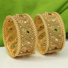 Ashura jewels beautiful wedding wear Polki Multi Beads bangle set this is a 2 pcs Kada bracelet gold polished bangle set this set is very easy to wear. we ship our items everywhere. Colour Red Green design bangle stone Pearl beads  2.4,2.6, Size available These openable bangles can be wear by 2.8 size person.   material gold plated Standard shipping takes 3 to 4 weeks to deliver the parcel if a customer needs an item urgently then we can ship the item through Express shipping it takes 3 to 6 day Yellow Gold Plated Cuff Bracelet For Wedding, Elegant Bangle With Intricate Design For Marriage, Intricate Design Bracelet Jewelry For Marriage, Gold-plated Bangle Cuff Bracelet For Wedding, Jeweled Yellow Gold Bangle Bracelet, Elegant Gold Meenakari Bracelets, Elegant Jeweled Gold Bangle, Elegant Jeweled Gold-plated Bangle, Elegant Gold Jeweled Bangle