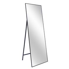 a mirror that is standing up against a white wall and it has a black frame