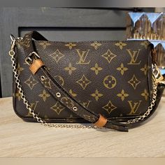 The Iconic Classic Louis Vuitton Pochette Accessoires In Monogram Coated Canvas And Vachetta Leather Accents. Its Secure Top Zip Closure Protects A Spacious Compartment. Gold Colored Zipper Works Perfectly. Comes With An Authentic Louis Vuitton Monogram Adjustable Strap 53" With Unbranded Gold Clips That Have Been Added. . A Gold Accessory Chain (Unbranded) Is Included. There Is A Bleach Type Discoloration In The Bottom Of The Interior Canvas. It Has Been Thoroughly Scrubbed Clean. Great Exterio Pochette Louis Vuitton, Gold Clips, Louis Vuitton Pochette, Leather Accents, Gold Accessories, Authentic Louis Vuitton, Brown Gold, Louis Vuitton Monogram, Louis Vuitton Bag