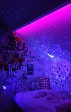 a bedroom with purple lights and pictures on the wall