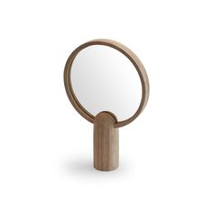 a round mirror with a wooden stand on the front and back sides, showing it's reflection