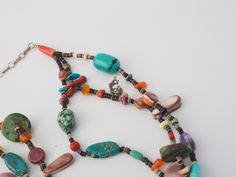 "Listing is for a vintage handmade southwestern mixed gemstones multi strand beads necklace with sterling silver adjustable chain and charms. Beautiful, mixed gemstones Native American style HEISHI necklace with large turquoise center piece. Necklace measures 16\" with 3\" of adjustable chain. Drops down to 4.5\". Stones are turquoise, corals, mother of pearls, agate, carnelian, jasper. There are two small charms of the Indian Chief in Feather Headdress and Kokopelli. Necklace is strung on nylon Southwestern Multi-strand Jewelry With Colorful Beads, Southwestern Multi-strand Colorful Beads Jewelry, Vintage Multi-strand Gemstone Bead Necklaces, Vintage Multi-strand Gemstone Beads Necklace, Bohemian Oval Bead Jewelry For Festivals, Southwestern Multi-strand Turquoise Gemstone Necklace, Southwestern Multi-strand Polished Bead Necklaces, Southwestern Multi-strand Turquoise Beaded Necklace, Southwestern Multi-strand Beaded Necklaces