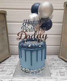 a blue birthday cake with balloons and happy birthday dad written on the top in metallic foil