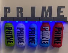 four different types of drinks hanging on a wall with the word prime lit up above them