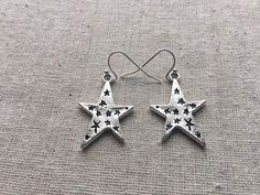 "Love these fun and whimsical star earrings! Made from allergy free, plated silver. They hang from silver plated simple hook earwires. The stars measure 1\" long by 3/4\" across. I have a matching necklace in my shop if you would like the whole set. https://www.etsy.com/listing/256162930/silver-star-necklace-silver-star-pendant?ref=shop_home_active_2 Thanks for stopping by and please take a look at the rest of my shop where you will find many more beautiful adornments. Tiger Flower Jewelry - Ins Celestial Star-shaped Hypoallergenic Earrings, Celestial Star Hypoallergenic Earrings, Silver Star-shaped Earrings, Big Star Earrings, Tiger Flower, Silver Star Earrings, Celestial Earrings, Star Necklace Silver, Earrings Star