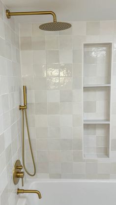 a bathtub with a shower head and thermostaer is shown in this bathroom