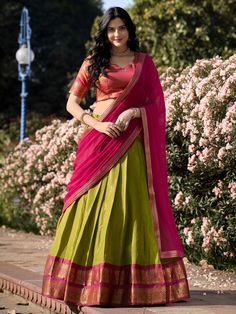 Introducing our stunning "excellent green zari weaving kanchipuram silk event wear lehenga choli" that is sure to make you stand out at any special occasion. This set includes a green color Kanchipuram silk lehenga with intricate zari weaving work, a pink color Kanchipuram silk choli also with zari weaving work, and a pink color georgette plain dupatta with lace border work.
The green lehenga is beautifully stitched up to 42 inches, with a 3.70-meter flair, and un-stitched choli material of 0.80 Half Saree Designs South Indian, Kanchipuram Lehenga, Dhavani Designs, Pink Half Sarees, Silk Half Saree, Onam Outfits, Lehenga Choli Designs, Simple Lehenga, Half Saree Lehenga