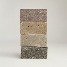 four different colored stone blocks stacked on top of each other