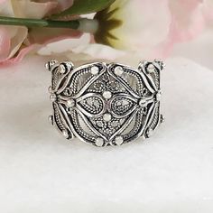 Handmade 925 Sterling Silver Filigree Wrap Around Wide Band Ring Material: 925 Solid Sterling Silver Ring face Length: 0.60 inches Finishing: Oxidized and Polished Comes with a gift pouch and box Free Domestic Shipping We hope that you enjoy our exclusive artisan handcrafted jewelry. Band Rings Women, Wide Band Ring, Mother Rings, Bohemian Rings, Sterling Silver Filigree, Nails Coffin, Wide Band Rings, Large Ring, Filigree Ring