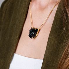 This glossy black Obsidian was hand-carved into a powerful, black panther and brought to life with sparkling Emerald eyes. This wild cat embodies grace and courage. We encased it in an 18k gold bezel with braided detail and prongs. Obsidian is considered to be a highly protective stone so wear it as a protection amulet. One of a kind. Technical Details Metal: 18k yellow goldRainbow Obsidian: 40.52 cts. Emerald EyesChain: can be worn at 16" and 18"Pendant Size: 24 x 22mmClosure: lobster claspHand Formal Hand Forged Black Jewelry, Formal Black Hand Forged Jewelry, Handmade Luxury Black Jewelry, Luxury Handmade Black Jewelry, Elegant Black Hand Forged Necklace, Black Panther Necklace, Panther Necklace, Mixed Metal Bracelets, Textile Necklace