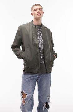 Every closet craves this sleek bomber jacket crafted with handy side pockets and comfy ribbed trim. Blade collar Ribbed cuffs and hem 100% polyester Machine wash, line dry Imported Casual Spring Varsity Jacket For Outdoors, Embroidered Long Sleeve Brown Outerwear, Spring Casual Varsity Jacket For Outdoor, Casual Varsity Jacket With Zipper For Spring, Urban Crew Neck Solid Color Outerwear, Casual Outerwear With Zip Cuffs And Relaxed Fit, Casual Outerwear With Ribbed Collar, Casual Solid Outerwear With Ribbed Collar, Casual Outerwear With Elastic Cuffs And Relaxed Fit