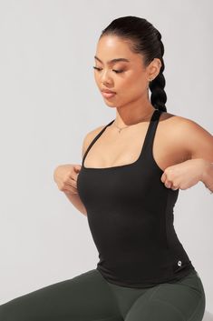 She is classy, she is chic, she is the Audrey Tank. You can dress her up for a night out, or add a fashion-forward flare to your next sweat session... there is no "right" way to style this tank (and that's our favorite part). Chic Yoga Tank Top With Built-in Bra, Stretch Top With Built-in Bra For Date Night, Stretch Tank Top With Built-in Bra For Date Night, Chic Workout Tank Top With Built-in Bra, Sleek Stretch Solid Color Tank Top, Trendy Sleeveless Activewear With Built-in Bra, Chic Fitted Seamless Tank Top, Sleek Seamless Workout Tops, High Stretch Trendy Tank Top For Night Out