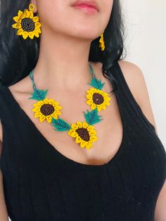 a woman wearing sunflower necklace and earrings