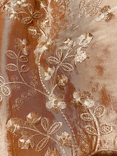 an embroidered fabric with gold and white flowers on brown velvet, from the collection's fall / winter 2013 collection