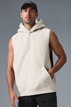 Stay cozy without sacrificing style in the Renown Sleeveless Hoodie. It has deep armholes, a kangaroo pocket, and a laid-back cut. And wait till you feel the Alo signature Renown fabric—it's smooth on the outside, a little fleecy on the side, and heavyweight for a just-right drape. Add shorts and you’re covered from the gym to the street. Casual Streetwear Vest With Dropped Armholes, Casual Sleeveless Hoodie For Workout, Sleeveless Cotton Hoodie For Loungewear, Athleisure Hoodie Top With Pockets, Sleeveless Hoodie With Drawstring Hood For Fall, Sleeveless Hoodie With Drawstring For Spring, Casual Stretch Sleeveless Hoodie, Sporty Sleeveless Alo Yoga Tank Top, Alo Yoga Sporty Sleeveless Tank Top