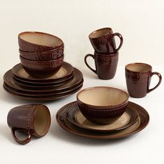 a set of brown dishes with cups and saucers