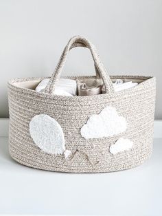 a basket with clouds on it sitting on a table