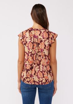 A classic short flutter sleeve top in a standout fall floral print. Floral print Relaxed fit Short flutter cap sleeves Hip length Split v-neckline with double tassel ties Bohemian fall top Dry clean recommended or hand wash cold Elevate your fall style with this flutter-sleeve top, featuring bohemian florals in autumnal hues. The split v-neckline with tassel ties adds a playful touch, while the hip-length fit keeps it versatile. Perfect for effortless boho-chic looks. Model is 5'9, wearing a siz Fall Floral Print Top With Flutter Sleeves, Floral Print Flutter Sleeve Tops For Fall, Fall Floral Print Blouse With Flutter Sleeves, Flutter Sleeve Blouse With Floral Print For Fall, Short Sleeve Floral Print Rayon Top, Floral Print Rayon Short Sleeve Tops, Short Sleeve Rayon Tops With Floral Print, Bohemian Top, Bohemian Fall