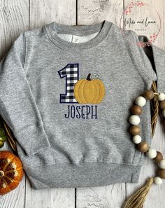 Boys First Birthday Fall Pumpkin Shirt and Sweatshirt, Pumpkin Birthday Welcome Fall with this adorable Boys Pumpkin Birthday design. Choose from Grey Sweatshirt (shown) or Grey T-shirt. Personalize child's name and age.  Sweatshirt and Tshirts run true to size.  T-shirt sizes are 12M, 18M, 2T, 3T, 4T, 5, 6, 8 Sweatshirt sizes are 2T- 3T, 4T, 5/6, 7 **WASHING INSTRUCTIONS** WASH INSIDE OUT COLD WATER WITH LIKE COLORS TUMBLE DRY LOW LOW IRON  NO DRY CLEANING PRODUCTION TIME  Production is 7 busin Fall Birthday Crew Neck Tops, Fall Crew Neck Birthday T-shirt, Crew Neck Birthday T-shirt For Fall, Graphic Print Tops For Birthday In Fall, Fall Birthday Tops With Name Print, Fall First Birthday Boy, Pumpkin First Birthday Boy, Fall First Birthday, Boys First Birthday