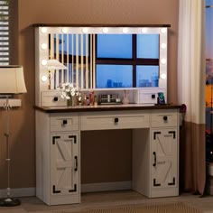 a dressing table with lights on it and a mirror in front of the window that is lit up