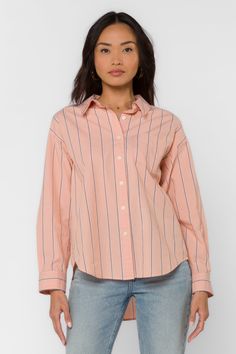 This Randall Peach Stripe Shirt is the perfect addition to your wardrobe. The long sleeve boyfriend shirt features a single chest pocket and a high low hem, making it both stylish and functional. The classic striped design adds a touch of sophistication to any outfit. Stay comfortable and fashionable with this must-have piece. Material: 100% Cotton Machine wash cold or hand wash Color: Peach Stripe Model is 5'9" and wearing a size S Imported Trendy Shirt With Shirttail Hem For Daywear, Trendy Shirt With Roll-up Sleeves And Shirttail Hem, Trendy Orange Cotton Blouse, Trendy Collared Shirt For Daywear, Pink Cotton Shirt With Placket, Trendy Cotton Tops With Spread Collar, Trendy Cotton Top With Spread Collar, Casual Orange Cotton Blouse, Pink Cotton Top With Shirttail Hem